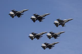 File: Polish Air Force F-16 fighters take part in a military parade in Warsaw on Polish Army Day